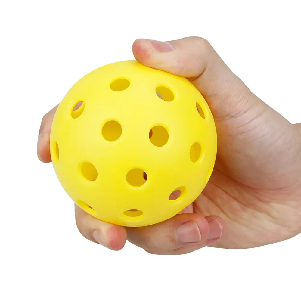 Image of hand holding yellow pickleball ball
