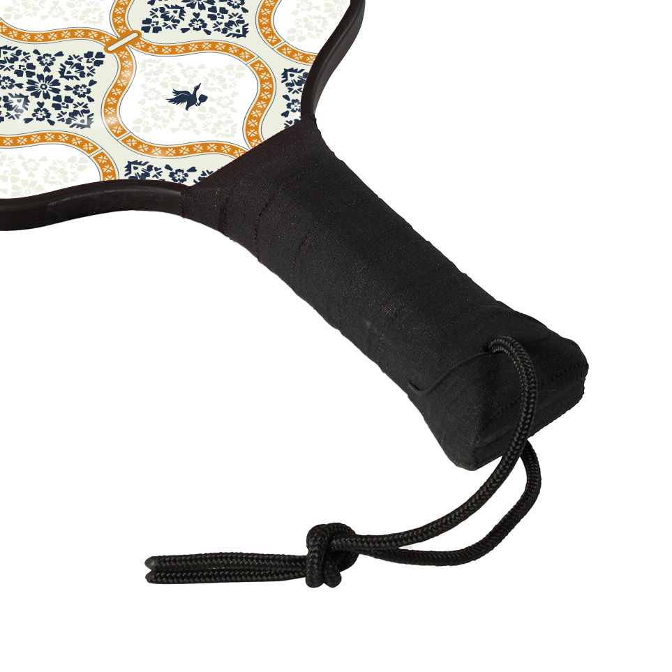 Close up handle view of wooden Tisdell pickleball paddle with a chai tea inspired pattern and a black wrapped handle from the Inception series.