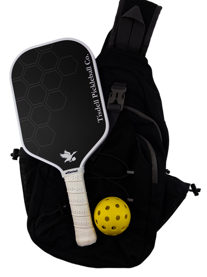 Black pickleball paddle and yellow ball with a black bag on a white background