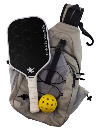 Pickleball paddle and ball with a bag on a white background