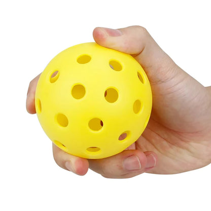 Image of hand holding yellow pickleball ball