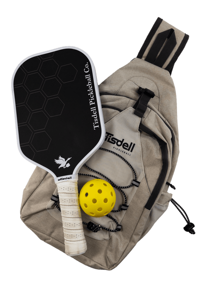 Tisdell pickleball paddle and yellow ball with beige bag on a transparent background