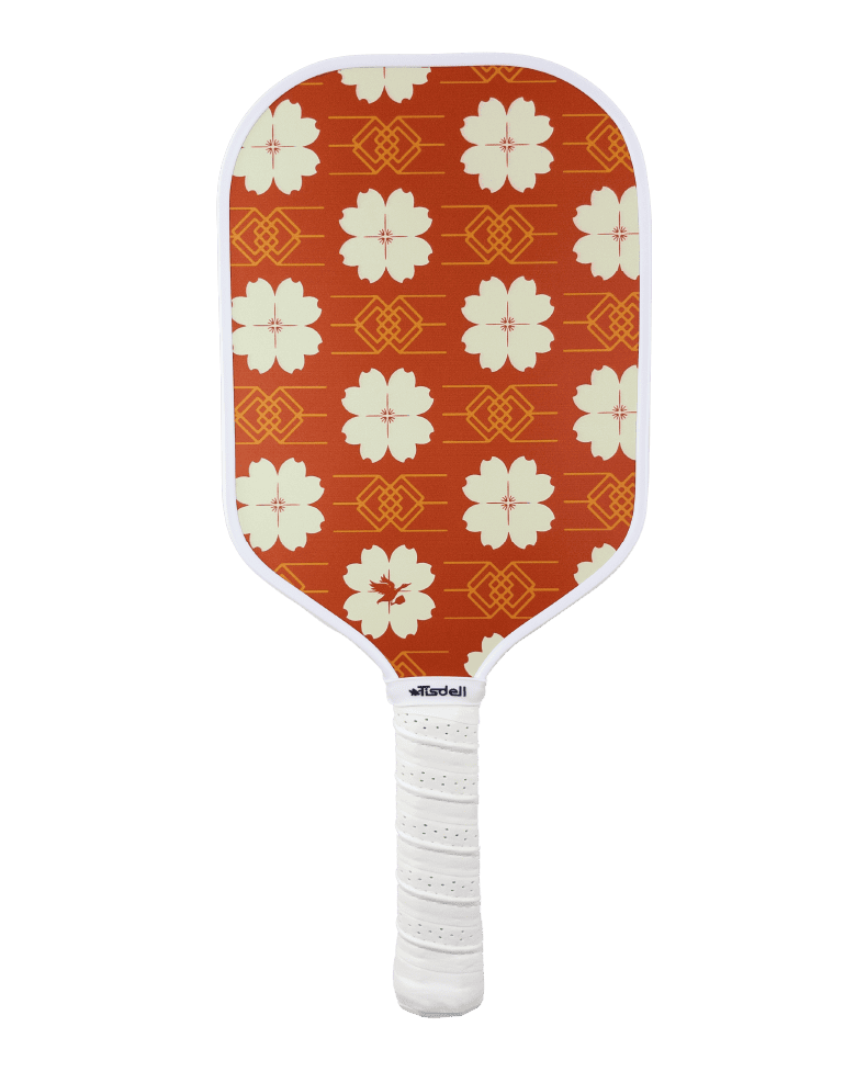 Pickleball paddle with red floral pattern on an white background