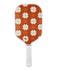 Pickleball paddle with red floral pattern on an white background