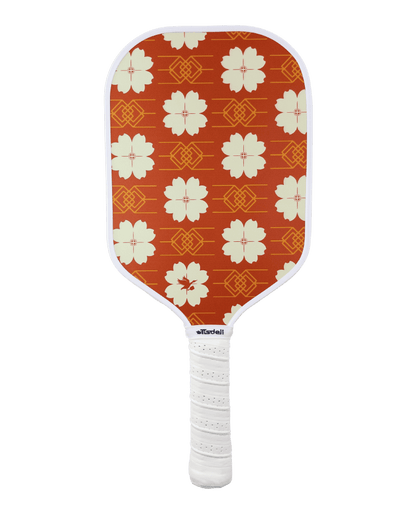 Pickleball paddle with red floral pattern on an white background