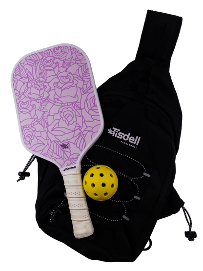 Purple pickleball paddle with floral pattern, yellow ball, and black bag on a transparent background
