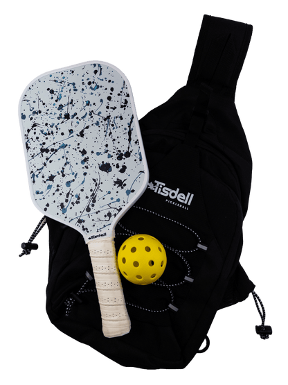 Pickleball paddle with splatter design, yellow ball, and black bag on a transparent background